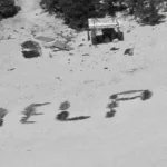 Tres náufragos fueron rescatados en una isla desierta tras escribir HELP en la arena de una playa