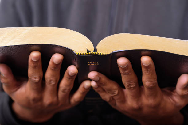 A close up view of a man hands holding the Holy Bible, Worship Concept